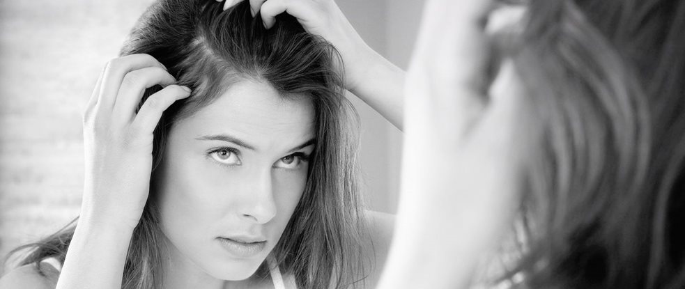 A woman checking for dandruff