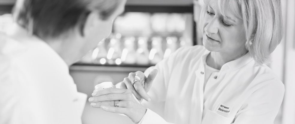Two scientists testing cream